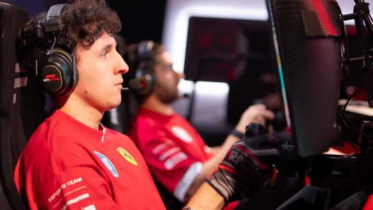 A Ferrari esports driver racing in a simulator rig wearing a headset