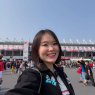 Mizuki smiling for a selfie at a Formula 1 circuit