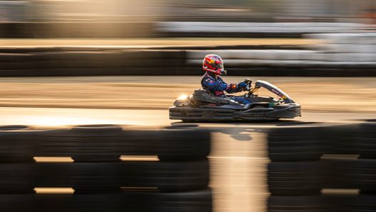 A kart blurred at speed on a karting track