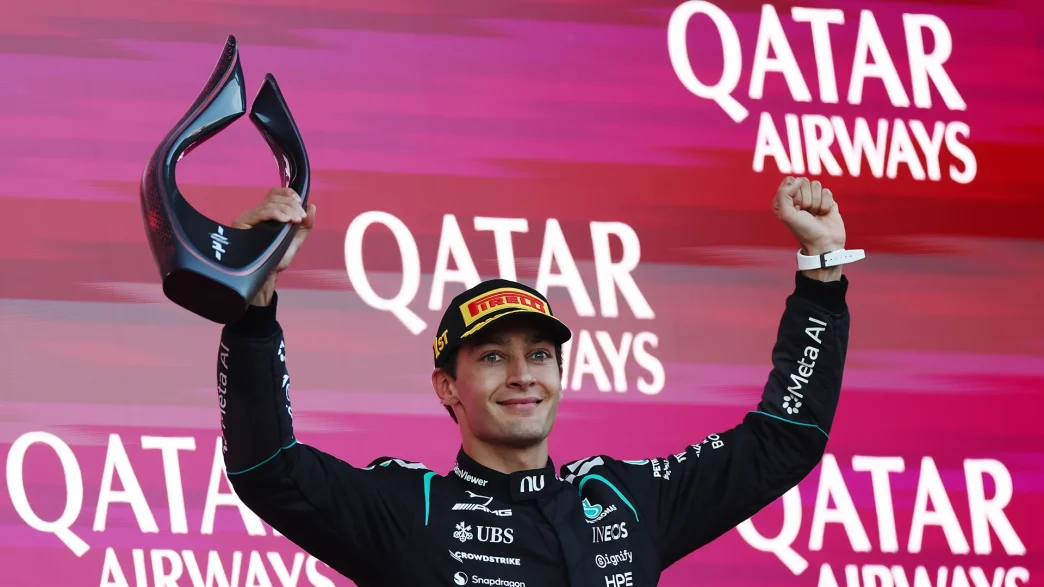George Russell lifting the winner's trophy on the podium in Baku