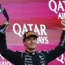 George Russell lifting the winner's trophy on the podium in Baku