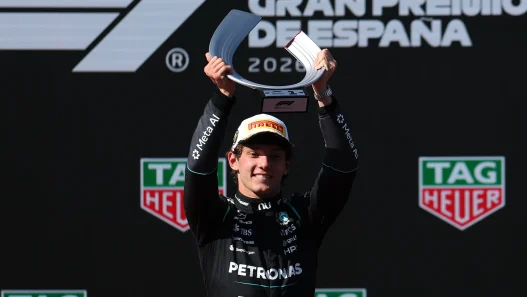 Kimi Antonelli lifts the winner’s trophy at the Spanish Grand Prix