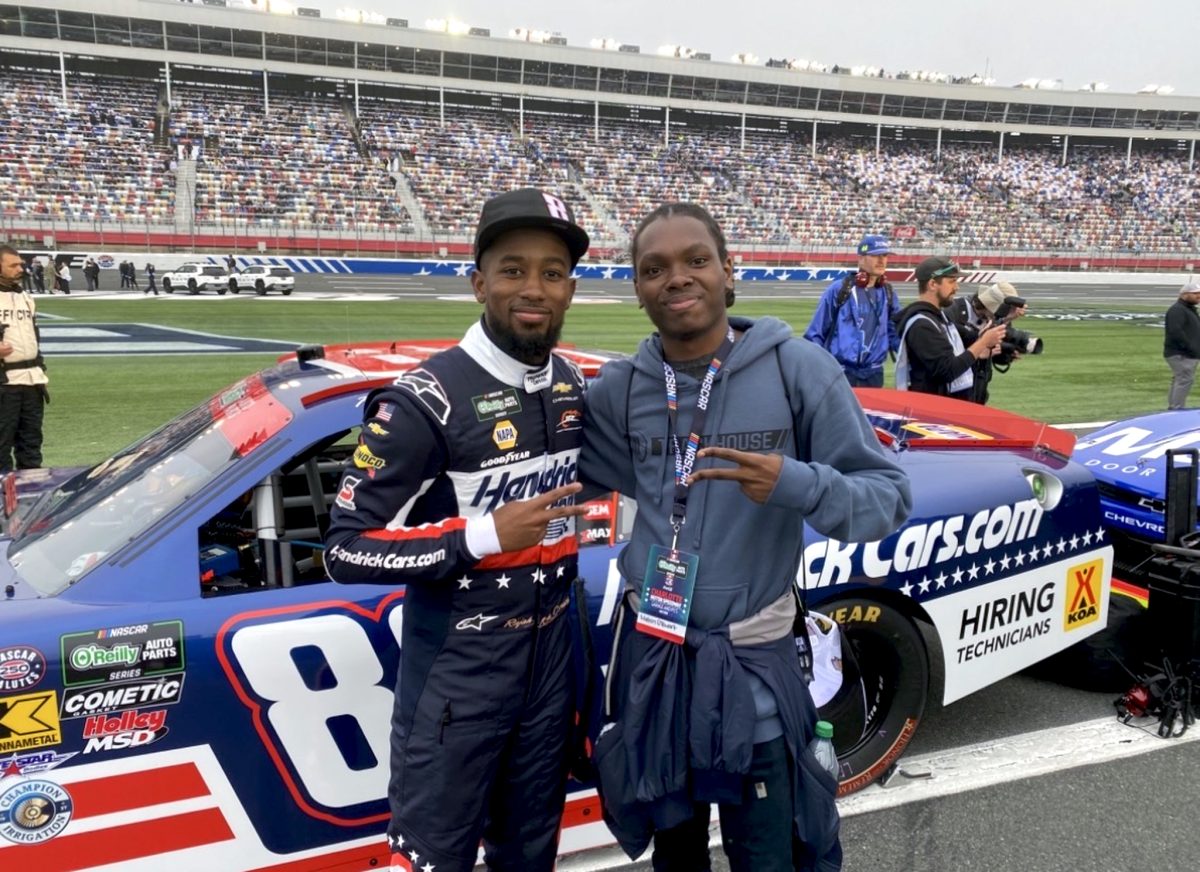 1NTERN with NASCAR driver Rajah Caruth beside his stock car