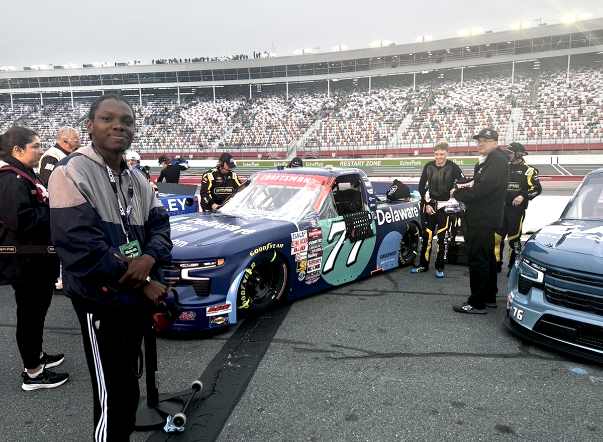 1NTERN on pit road beside Connor Zilisch’s No. 77 Spire Motorsports truck