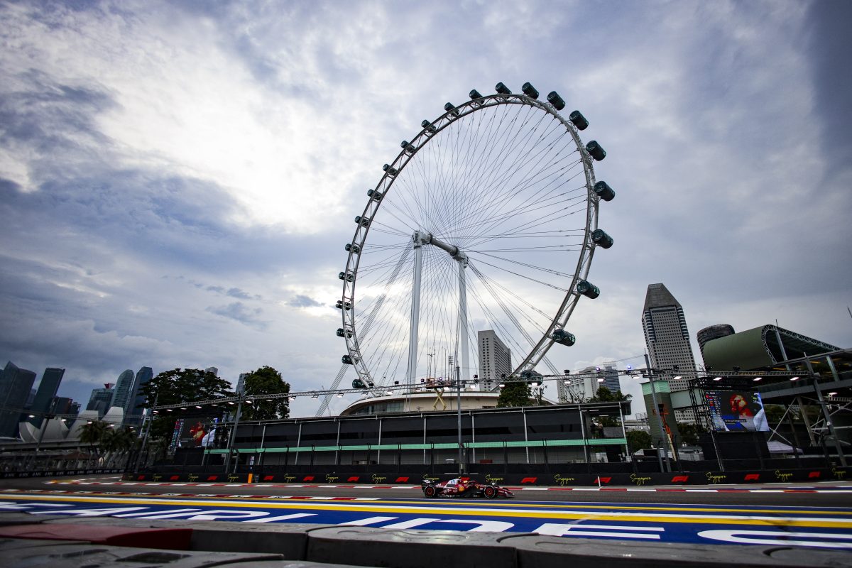 Lewis Hamilton’s Ferrari on track in daylight practice below the Singapore Flyer