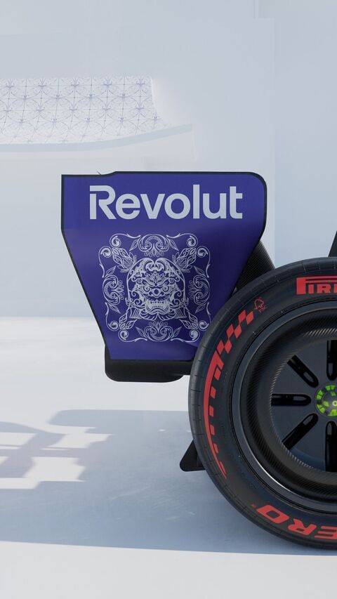 A rear wing endplate with a blue pattern beside a Pirelli tyre
