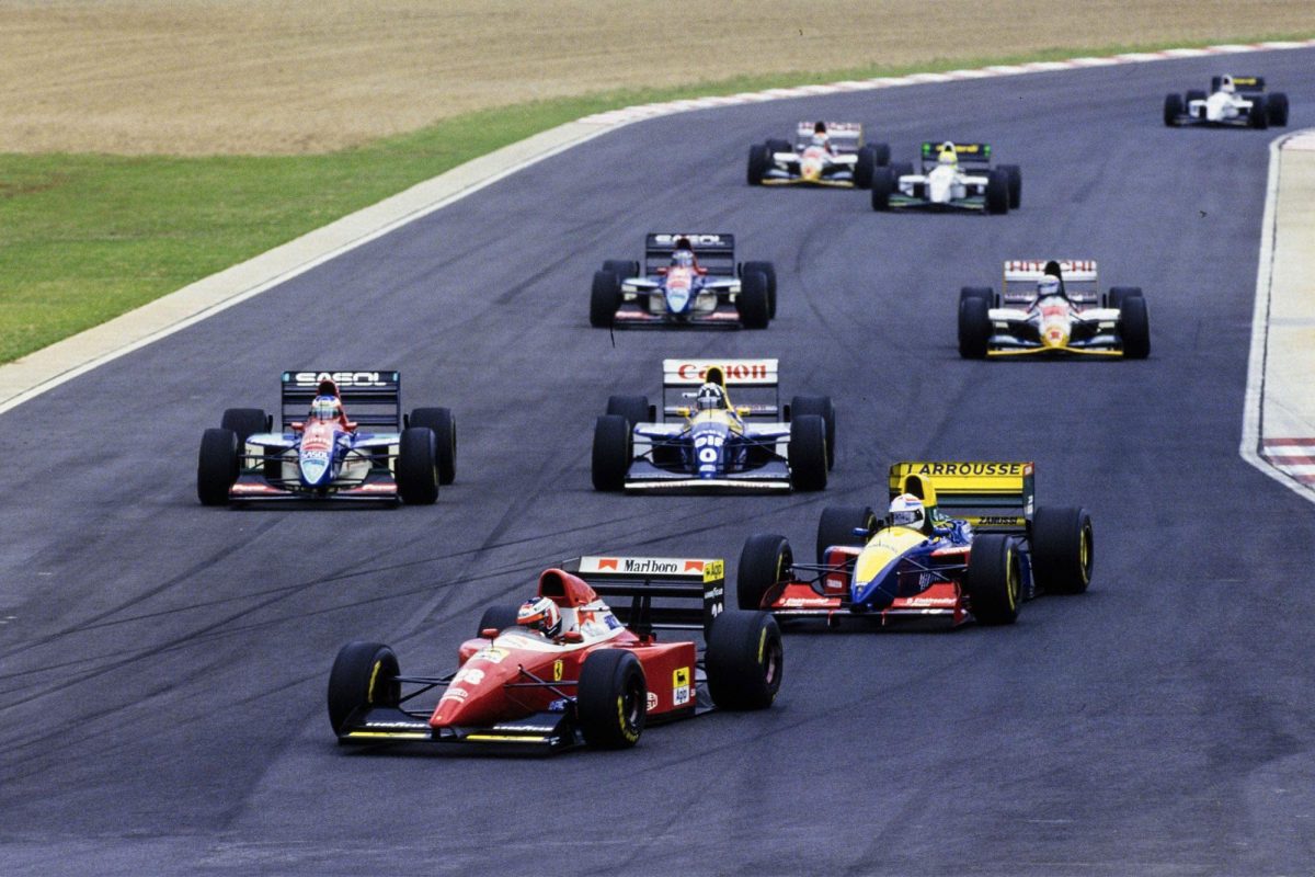 Gerhard Berger’s red Ferrari leading a group of 1993 Formula 1 cars at Kyalami