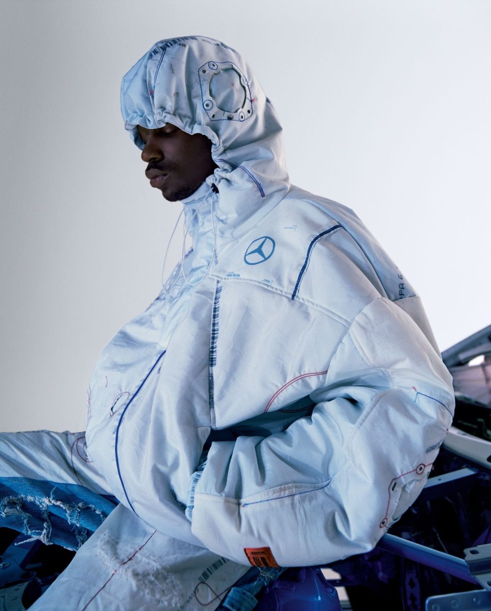 A model in a white hooded look made from recycled airbag material, from the Mercedes-Benz collection