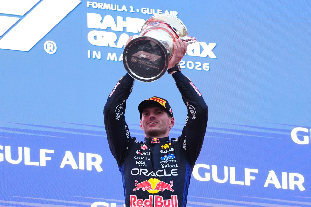 Max Verstappen lifting the winner’s trophy on the podium at Sepang