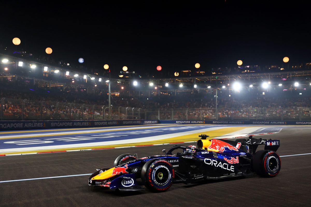 Max Verstappen’s Red Bull on track at night under the Marina Bay floodlights