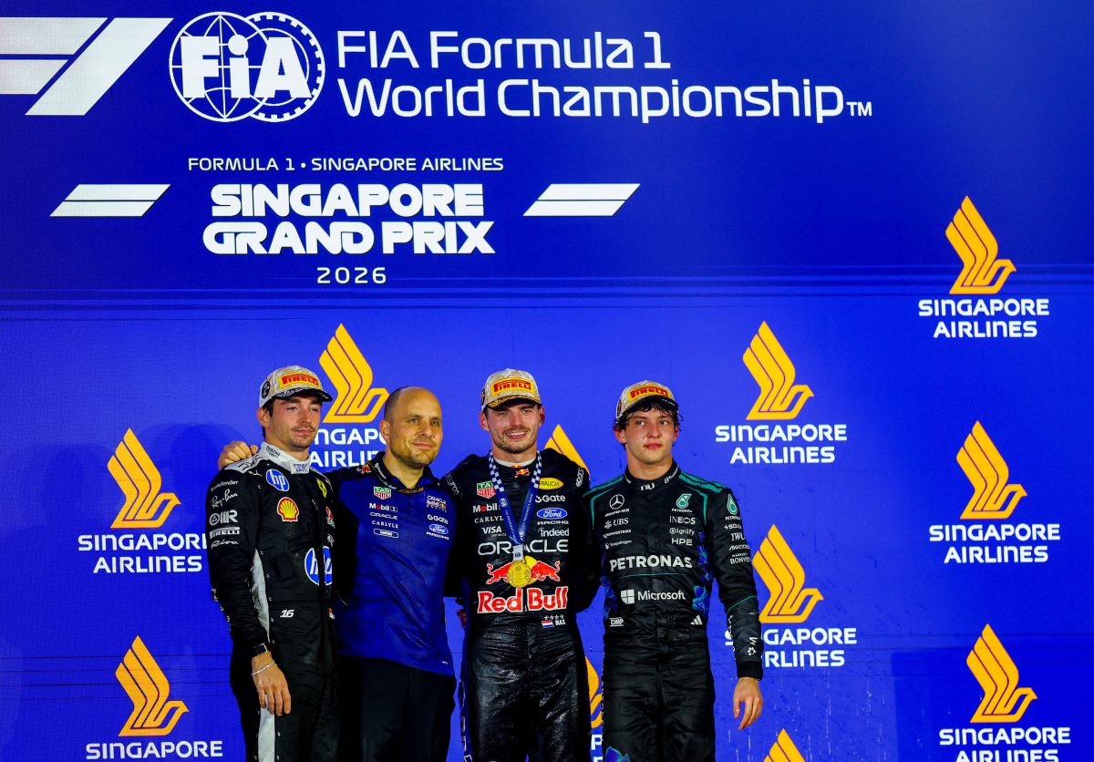 Max Verstappen and Gianpiero Lambiase on the Singapore Grand Prix podium with Charles Leclerc and Kimi Antonelli