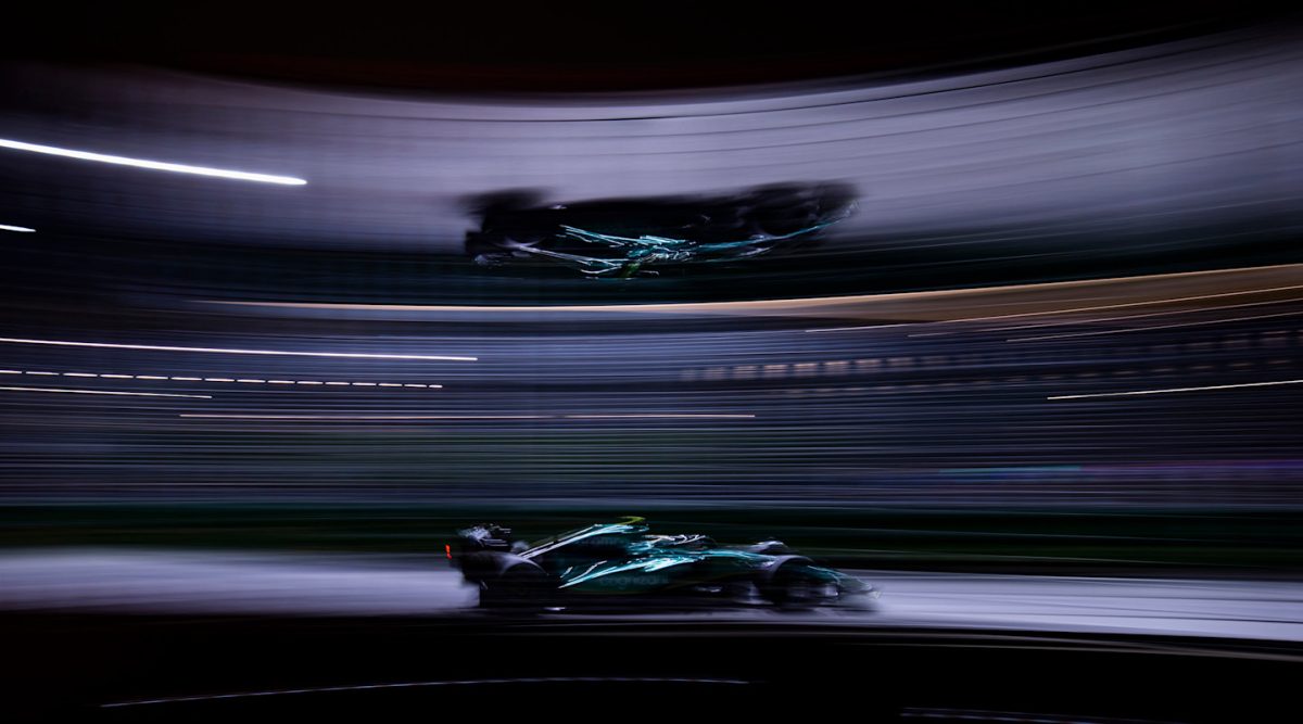 Fernando Alonso’s car streaking past under the lights at night