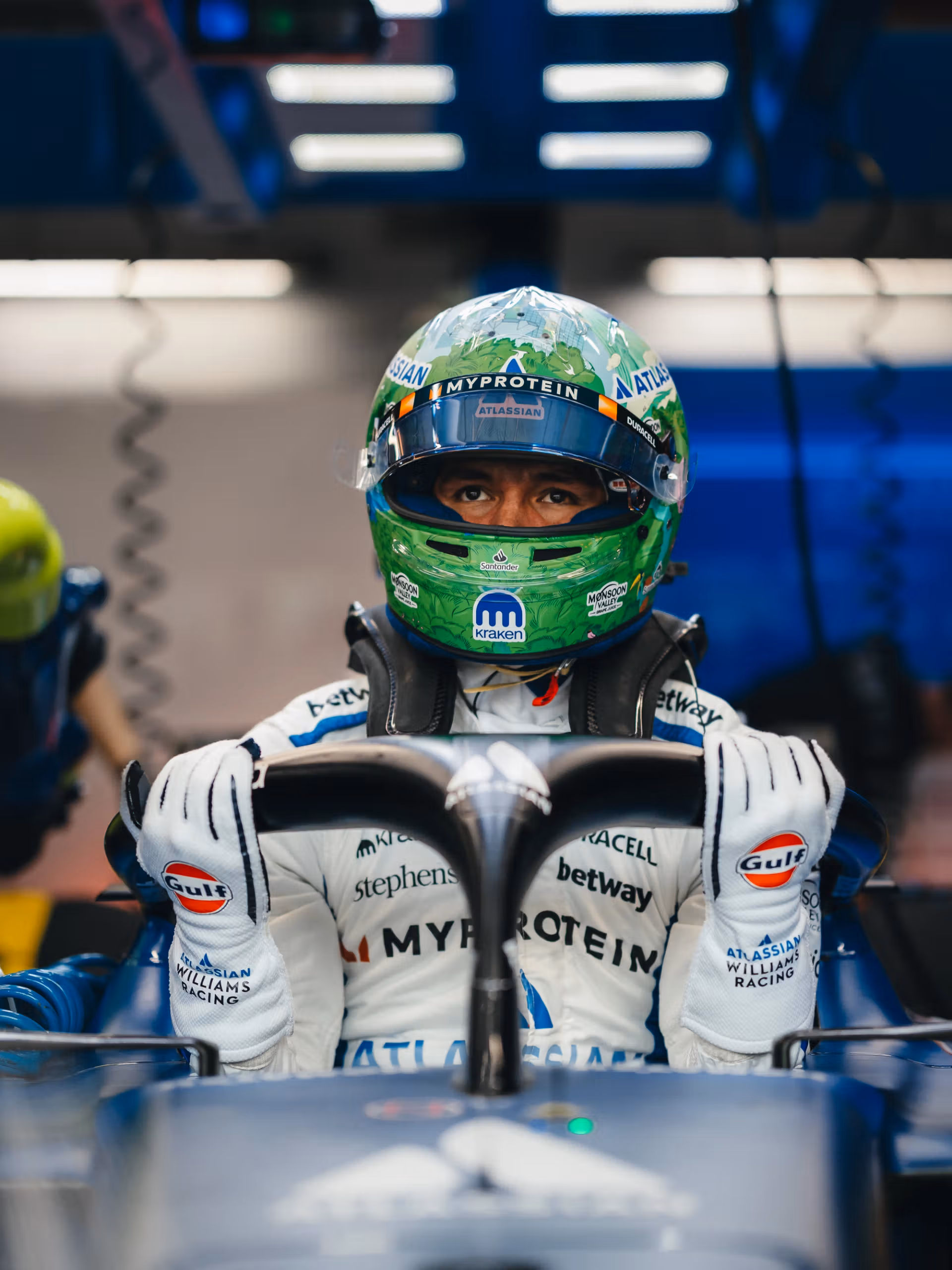 Alex Albon in the Williams garage, wearing his 2025 Singapore helmet