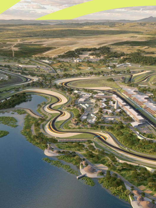 Aerial render of a winding racing circuit beside a lake, with grandstands and green hills
