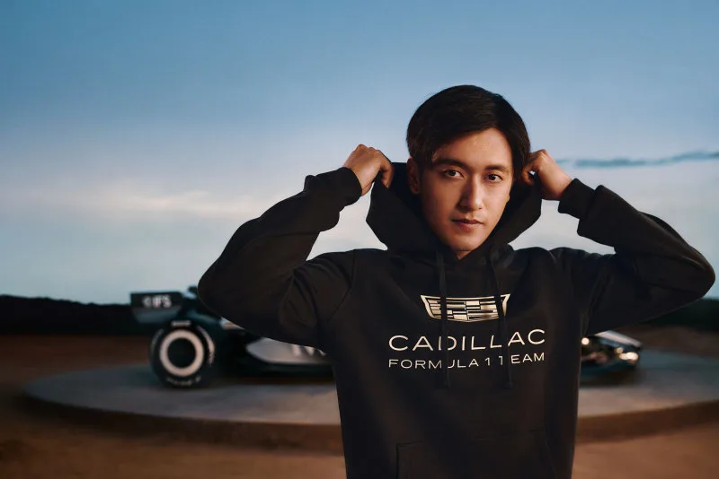 Zhou Guanyu wearing the Tommy Hilfiger x Cadillac F1 driver-replica piece