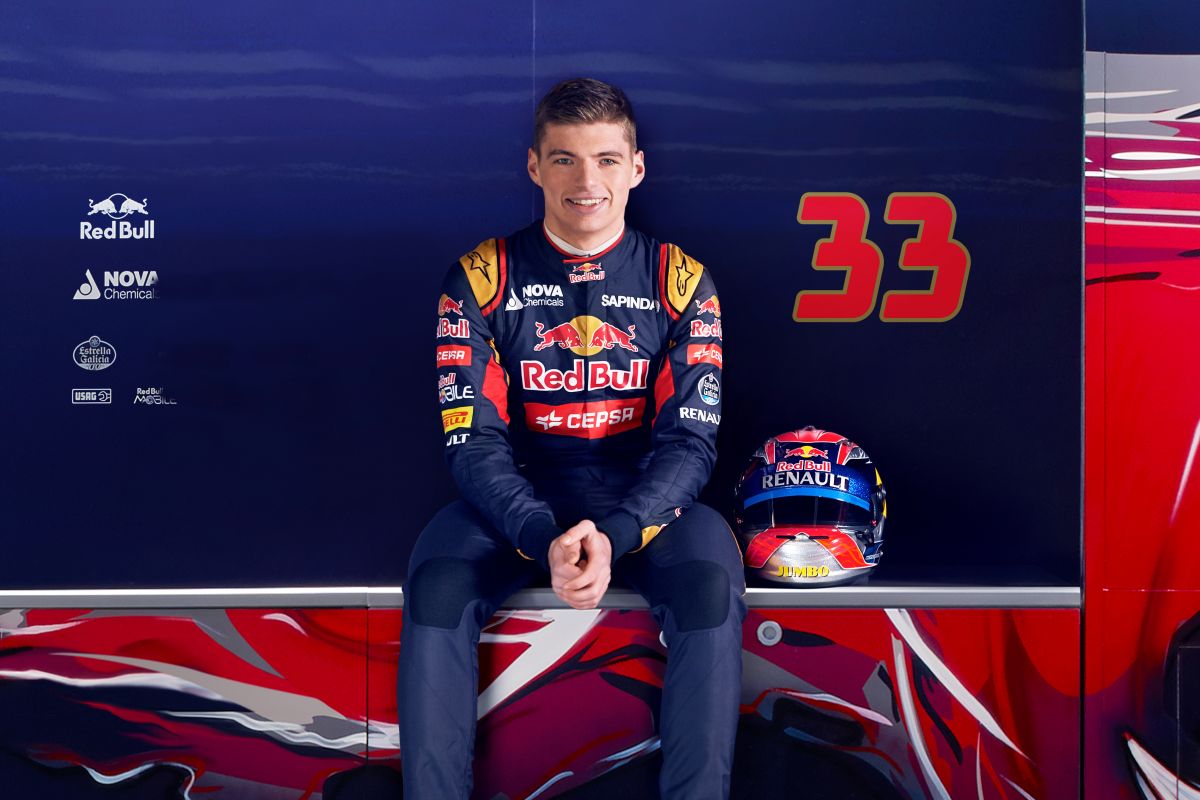 A 17-year-old Max Verstappen in his Toro Rosso race suit, sitting beside his helmet and a large number 33